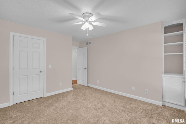 1039 Bluff Ln, Le Claire, IA 52753 - unfurnished bedroom with carpet, a textured ceiling, and a ceiling fan