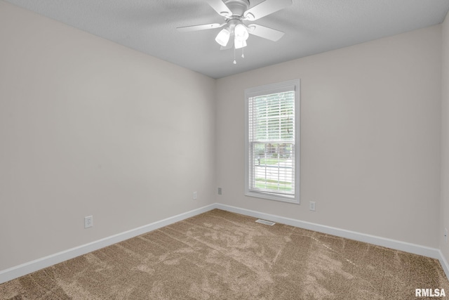1039 Bluff Ln, Le Claire, IA 52753 - carpeted spare room featuring a ceiling fan and a textured ceiling