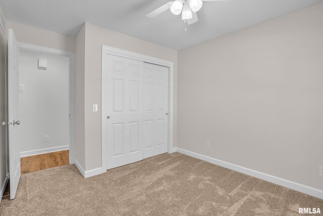 1039 Bluff Ln, Le Claire, IA 52753 - unfurnished bedroom with carpet, a closet, and ceiling fan