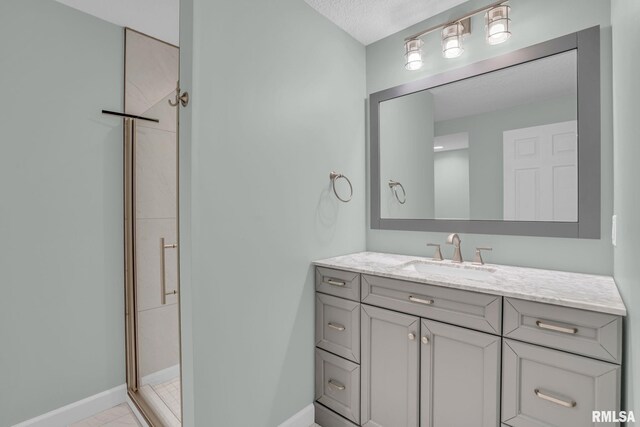 1039 Bluff Ln, Le Claire, IA 52753 - bathroom with vanity, a shower stall, and a textured ceiling