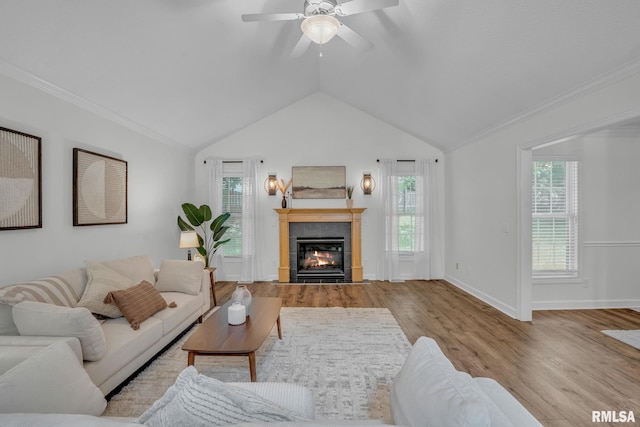 1039 Bluff Ln, Le Claire, IA 52753 - living area featuring wood finished floors, a tiled fireplace, ceiling fan, and vaulted ceiling