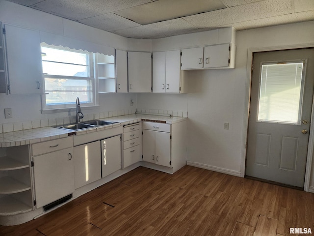 625 W Prospect St, Kewanee, IL 61443 - kitchen with open shelves, tile counters, white cabinetry, a paneled ceiling, and dark wood-type flooring