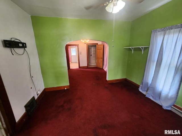 625 W Prospect St, Kewanee, IL 61443 - empty room with arched walkways, dark colored carpet, and ceiling fan
