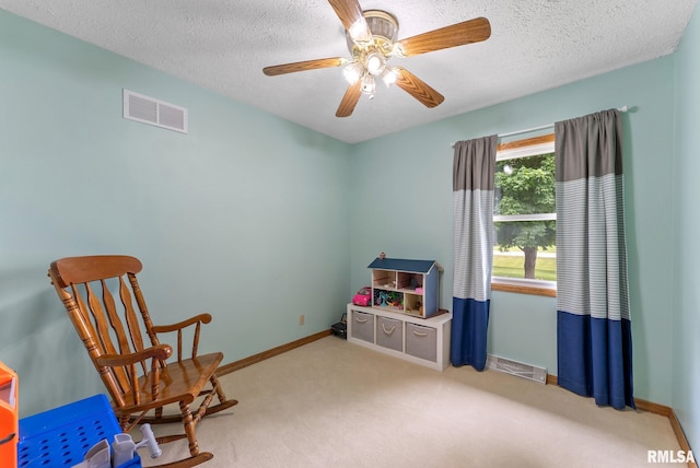 13118 65th Ave, Blue Grass, IA 52726 - sitting room featuring a textured ceiling, carpet floors, and a ceiling fan