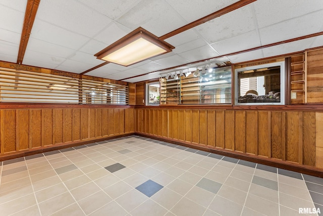 13118 65th Ave, Blue Grass, IA 52726 - empty room featuring wood walls and a paneled ceiling