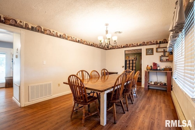 17000 Log Cabin Rd, Marion, IL 62959 - dining area featuring a chandelier, wood finished floors, and a textured ceiling