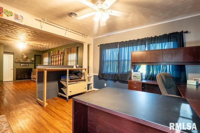 17000 Log Cabin Rd, Marion, IL 62959 - home office featuring ornate columns, a ceiling fan, wood finished floors, and a fireplace