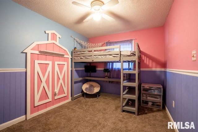 17000 Log Cabin Rd, Marion, IL 62959 - bedroom featuring a textured ceiling, a wainscoted wall, carpet flooring, and a ceiling fan