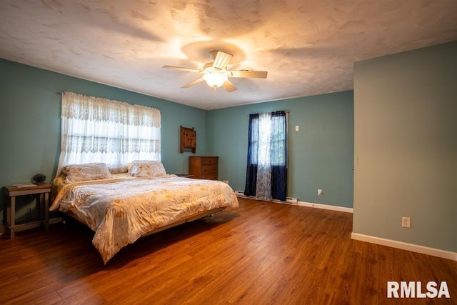 17000 Log Cabin Rd, Marion, IL 62959 - bedroom featuring multiple windows, wood finished floors, and ceiling fan