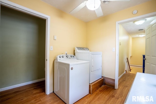 17000 Log Cabin Rd, Marion, IL 62959 - laundry room featuring separate washer and dryer, light wood-type flooring, and a ceiling fan