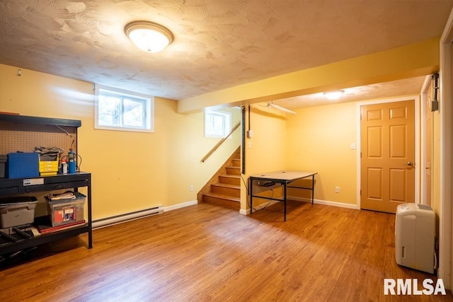 17000 Log Cabin Rd, Marion, IL 62959 - basement featuring a baseboard heating unit, wood finished floors, and stairs