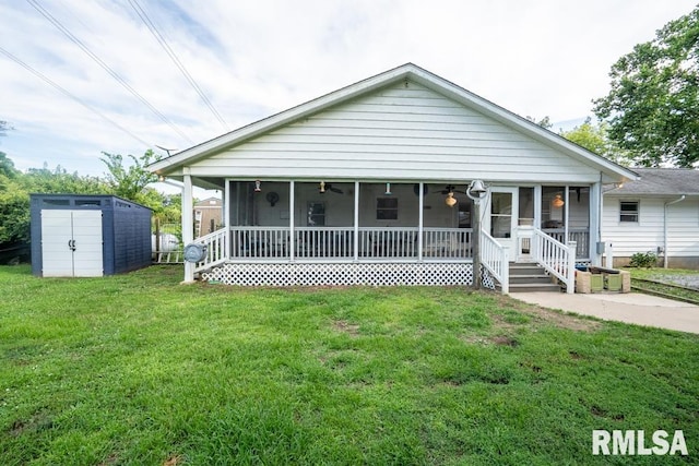 17000 Log Cabin Rd, Marion, IL 62959 - view of front of house with a sunroom, a storage shed, a front yard, and ceiling fan