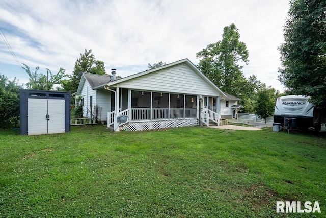 17000 Log Cabin Rd, Marion, IL 62959 - rear view of property with a storage shed, a sunroom, and a yard