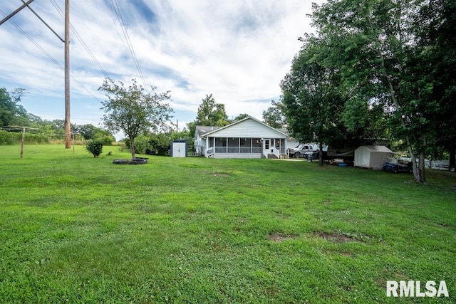 17000 Log Cabin Rd, Marion, IL 62959 - view of green lawn featuring a storage shed and a sunroom