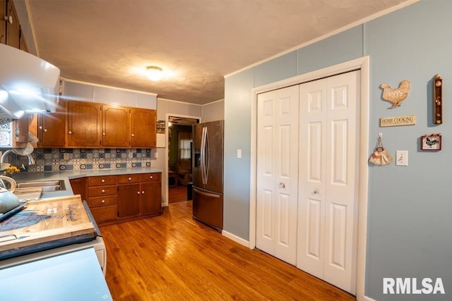 17000 Log Cabin Rd, Marion, IL 62959 - kitchen featuring stainless steel refrigerator with ice dispenser, light wood finished floors, brown cabinets, tasteful backsplash, and light countertops