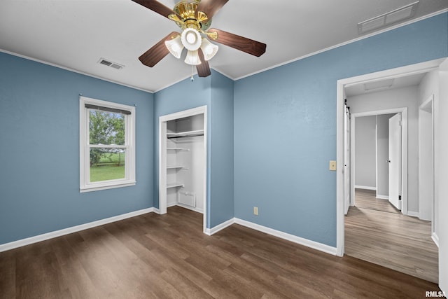 1671 US Highway 67, Preemption, IL 61276 - unfurnished bedroom featuring dark wood-type flooring, a closet, ceiling fan, and ornamental molding