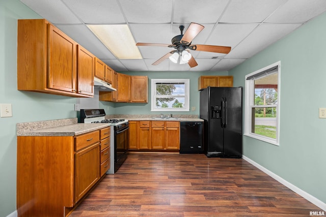1671 US Highway 67, Preemption, IL 61276 - kitchen with black appliances, under cabinet range hood, a ceiling fan, dark wood finished floors, and light countertops