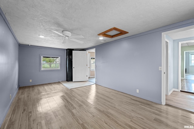1671 US Highway 67, Preemption, IL 61276 - unfurnished room with attic access, healthy amount of natural light, wood finished floors, and a textured ceiling