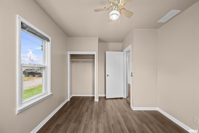 1671 US Highway 67, Preemption, IL 61276 - unfurnished bedroom with dark wood finished floors, multiple windows, a closet, and a ceiling fan