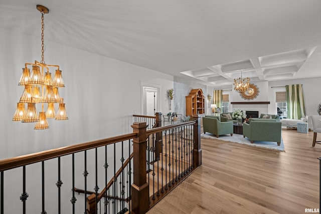 5835 Pigeon Creek Rd, Bettendorf, IA 52722 - hallway featuring a chandelier, an upstairs landing, coffered ceiling, wood finished floors, and beamed ceiling