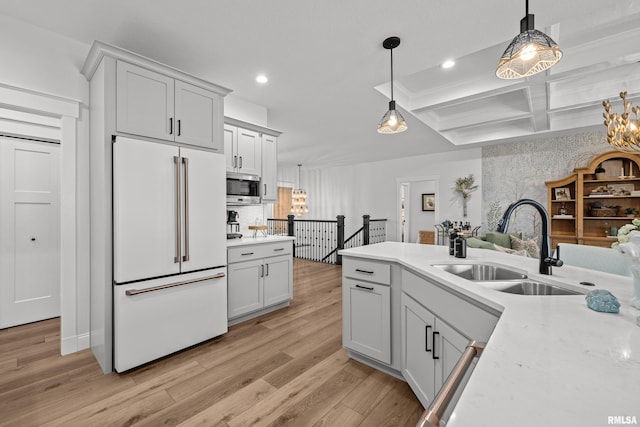5835 Pigeon Creek Rd, Bettendorf, IA 52722 - kitchen with built in fridge, stainless steel microwave, a chandelier, light countertops, and recessed lighting