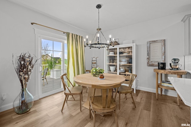 5835 Pigeon Creek Rd, Bettendorf, IA 52722 - dining area with a chandelier and light wood-style floors