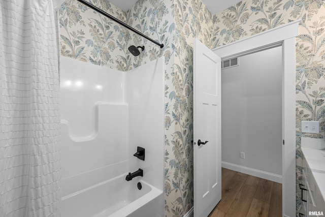 5835 Pigeon Creek Rd, Bettendorf, IA 52722 - full bathroom featuring wood finished floors, wallpapered walls, shower / bath combination with curtain, and vanity