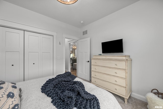 5835 Pigeon Creek Rd, Bettendorf, IA 52722 - bedroom with a chandelier, carpet floors, and a closet
