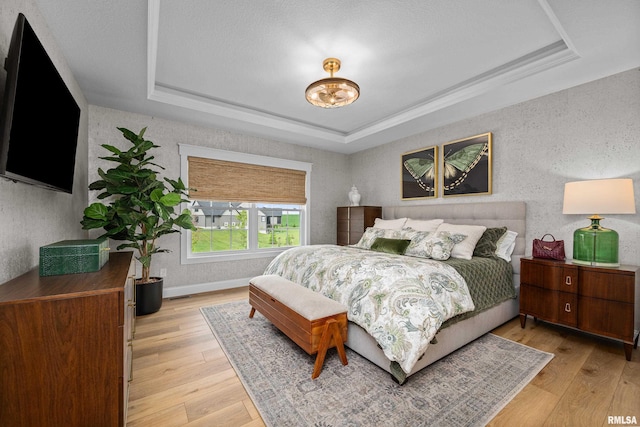 5835 Pigeon Creek Rd, Bettendorf, IA 52722 - bedroom featuring a raised ceiling and light wood-style floors