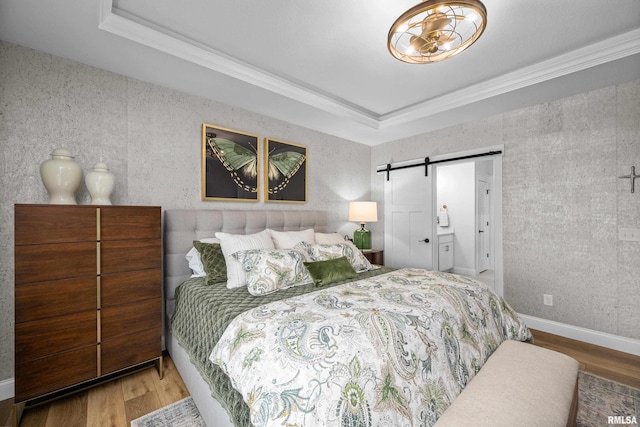5835 Pigeon Creek Rd, Bettendorf, IA 52722 - bedroom with a barn door, wood finished floors, ornamental molding, and a raised ceiling