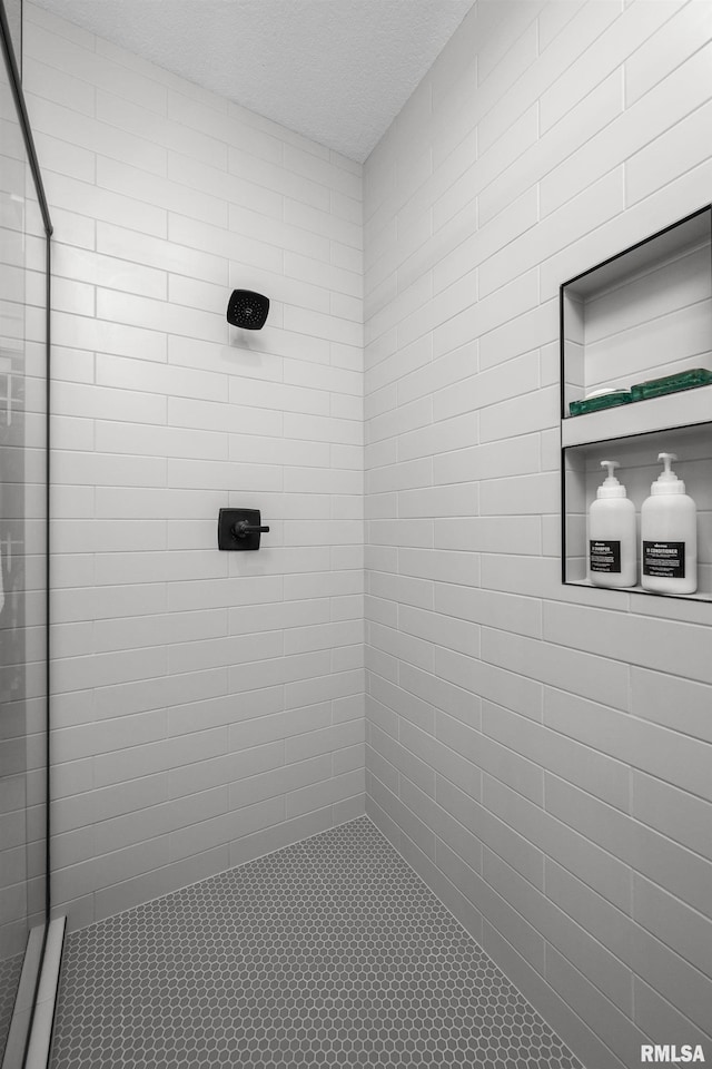 5835 Pigeon Creek Rd, Bettendorf, IA 52722 - full bathroom with tiled shower, a textured ceiling, and tile patterned flooring