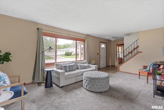 505 N 7th St, Eldridge, IA 52748 - carpeted living room featuring baseboards and stairway