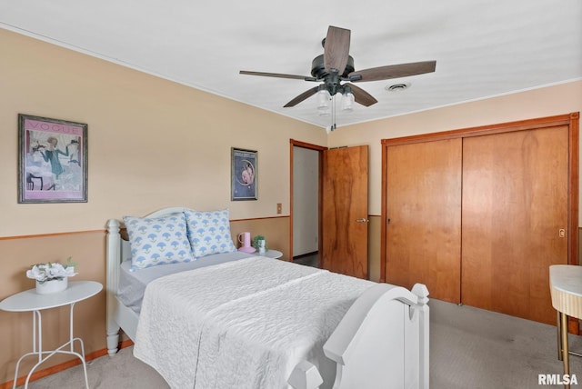 505 N 7th St, Eldridge, IA 52748 - bedroom featuring light carpet, a closet, and a ceiling fan