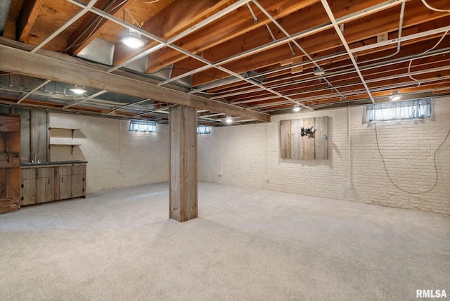 505 N 7th St, Eldridge, IA 52748 - below grade area featuring brick wall and carpet flooring