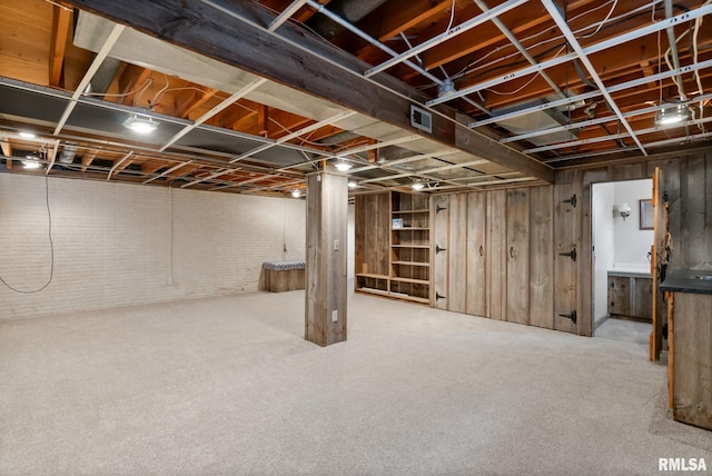 505 N 7th St, Eldridge, IA 52748 - basement with carpet flooring and wooden walls