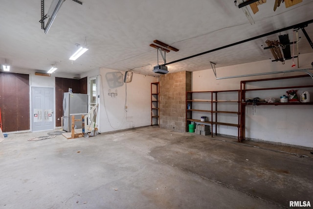 505 N 7th St, Eldridge, IA 52748 - garage featuring freestanding refrigerator and a garage door opener