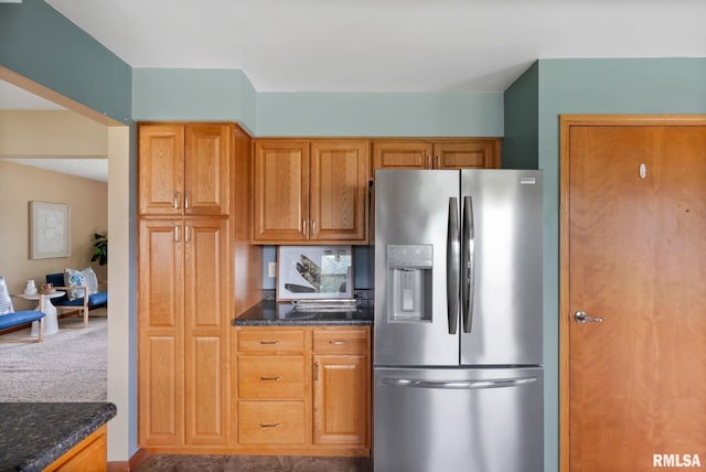 505 N 7th St, Eldridge, IA 52748 - kitchen featuring stainless steel fridge, dark stone countertops, and brown cabinetry