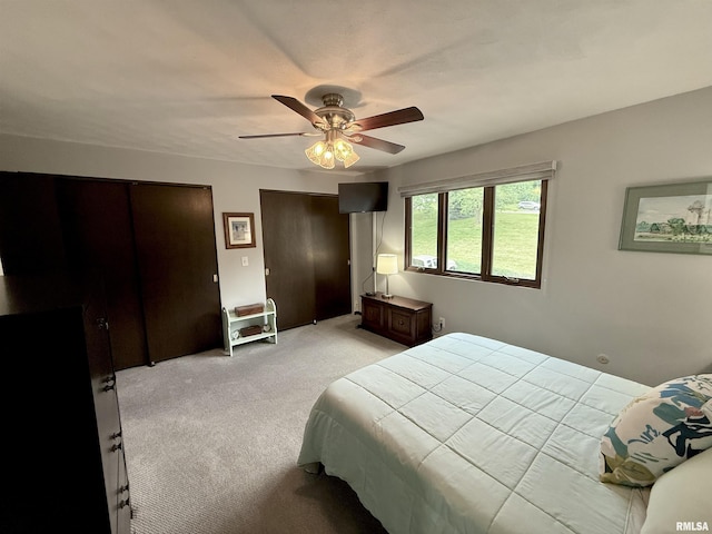 3715 35th St Unit 3, Moline, IL 61265 - bedroom featuring light carpet, two closets, and ceiling fan