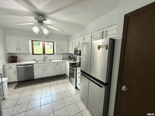 3715 35th St Unit 3, Moline, IL 61265 - kitchen featuring appliances with stainless steel finishes, white cabinetry, a ceiling fan, light countertops, and light tile patterned flooring