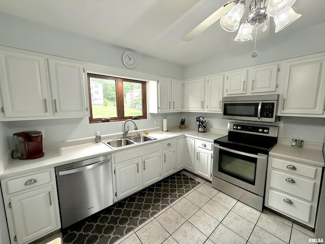 3715 35th St Unit 3, Moline, IL 61265 - kitchen with appliances with stainless steel finishes, light tile patterned floors, light countertops, and white cabinetry