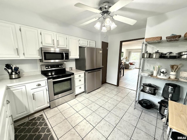 3715 35th St Unit 3, Moline, IL 61265 - kitchen with appliances with stainless steel finishes, light tile patterned floors, light countertops, and white cabinets