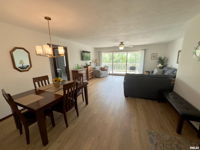 3715 35th St Unit 3, Moline, IL 61265 - dining space featuring light wood-type flooring, a chandelier, and a ceiling fan