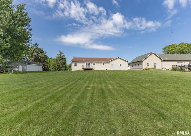 95 N 18th St, Clinton, IA 52732 - rear view of house featuring a lawn and a wooden deck
