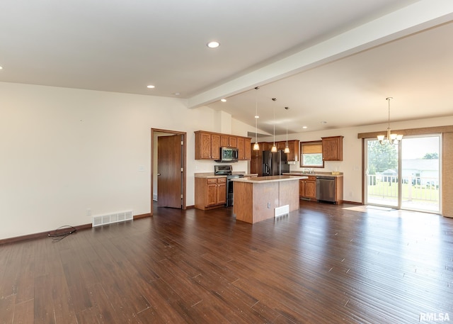 95 N 18th St, Clinton, IA 52732 - kitchen with stainless steel appliances, a chandelier, a kitchen island, light countertops, and dark wood-style flooring