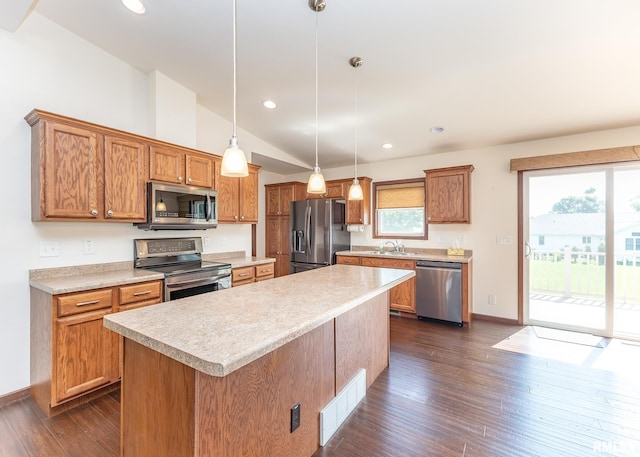 95 N 18th St, Clinton, IA 52732 - kitchen featuring appliances with stainless steel finishes, light countertops, vaulted ceiling, dark wood-type flooring, and a kitchen island