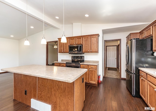 95 N 18th St, Clinton, IA 52732 - kitchen featuring appliances with stainless steel finishes, a kitchen island, dark wood finished floors, light countertops, and brown cabinetry