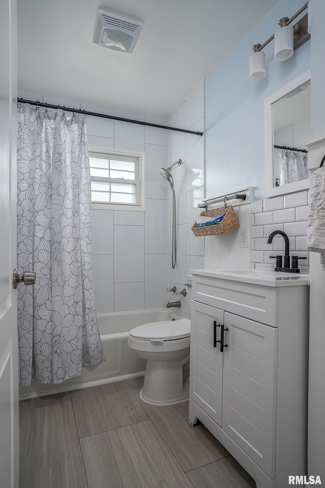 3118 W Denison Ave, Davenport, IA 52804 - bathroom featuring vanity, shower / bath combination with curtain, wood finished floors, and tasteful backsplash