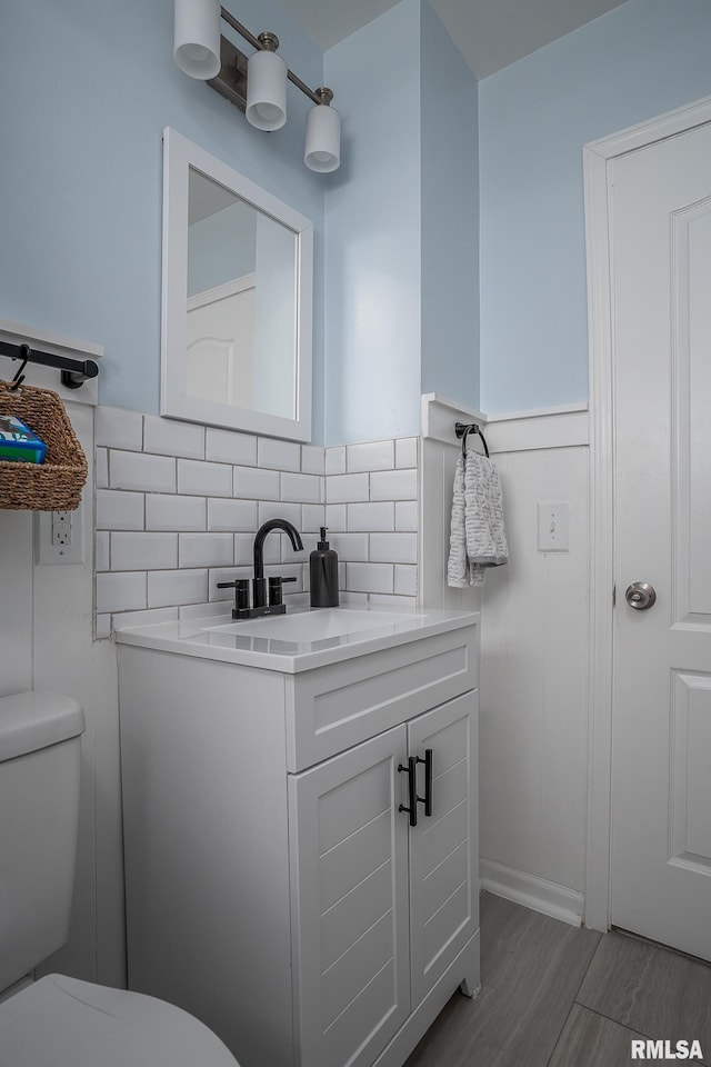 3118 W Denison Ave, Davenport, IA 52804 - bathroom with vanity, wood finished floors, and backsplash