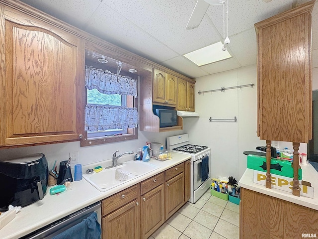 1426 32nd St, Rock Island, IL 61201 - kitchen featuring gas range gas stove, dishwasher, black microwave, light countertops, and light tile patterned floors