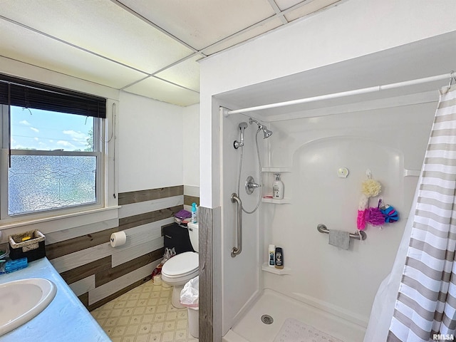 1426 32nd St, Rock Island, IL 61201 - bathroom with tile patterned floors, a shower with shower curtain, vanity, and a wainscoted wall